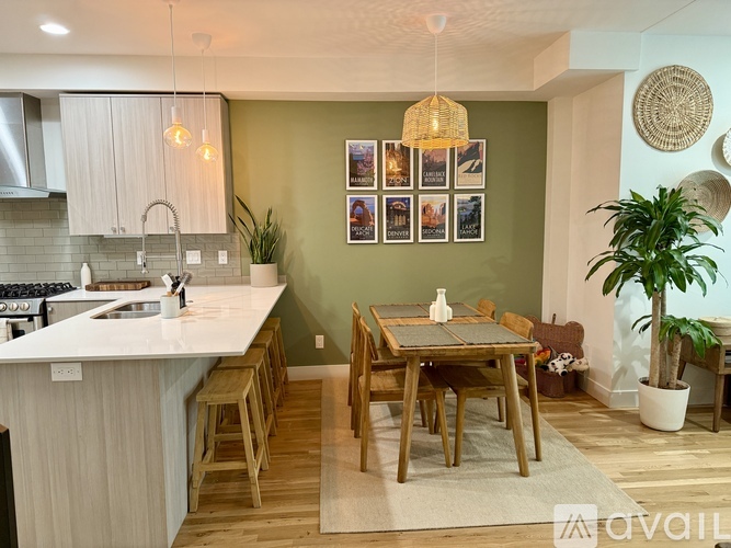 A kitchen with a dining table and chairs.