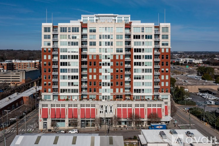 A tall red and white building with many windows.