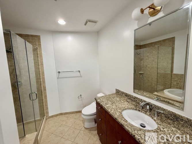 A bathroom with a sink, toilet, and shower.