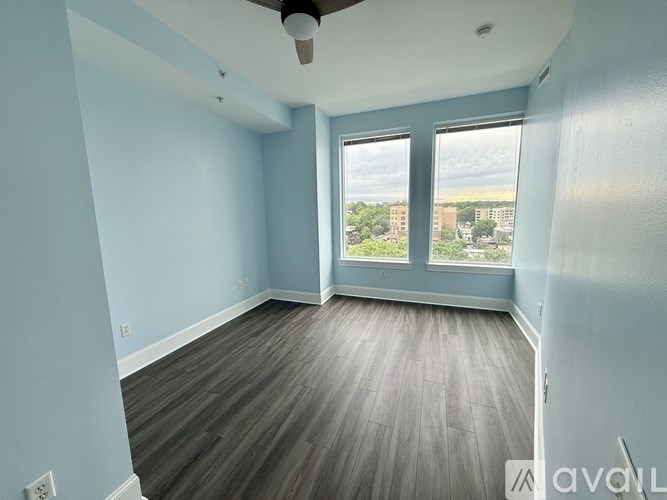 A room with a ceiling fan and hardwood flooring.