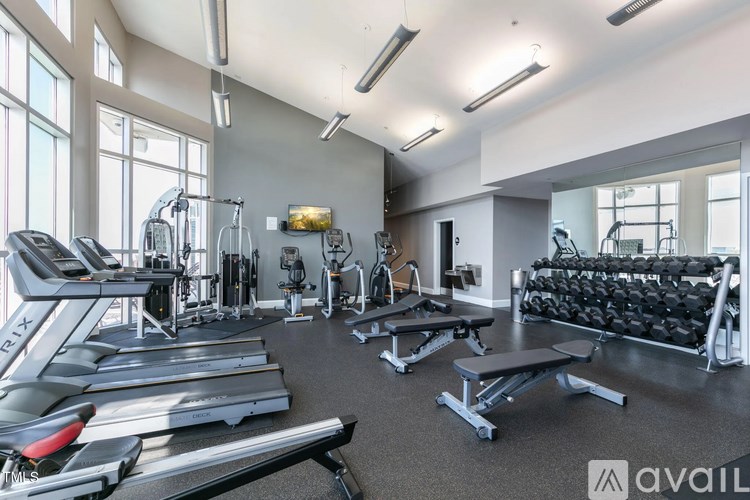 A gym with treadmills, weights, and exercise equipment.