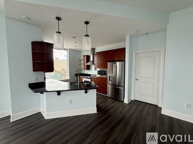 A kitchen with a black countertop and wooden cabinets.