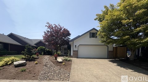 A house with a garage and a driveway with a stone path.