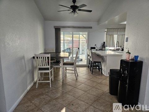 A kitchen area with a dining table and chairs.