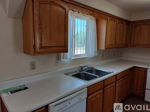 A kitchen with wooden cabinets and a white countertop.