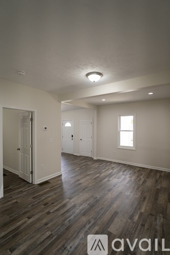 A room with wooden floors and a window.