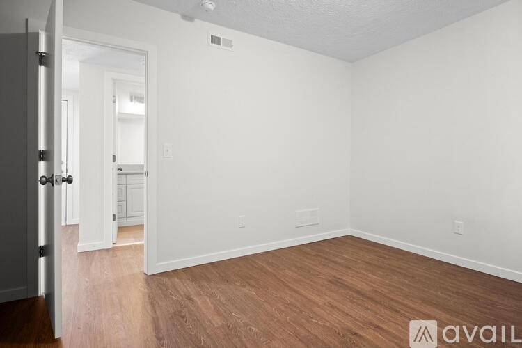 A room with wooden floors and white walls.