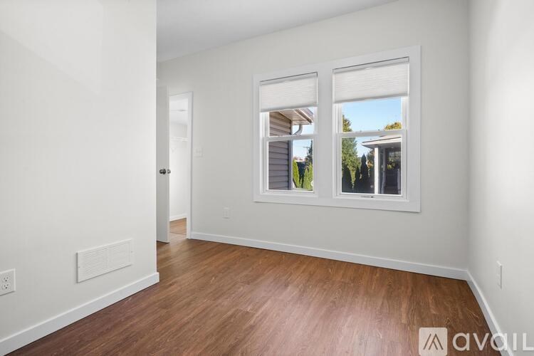 A long pipe runs along the ceiling of a room.
