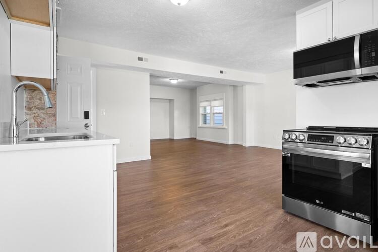 A kitchen with white cabinets and a black oven.