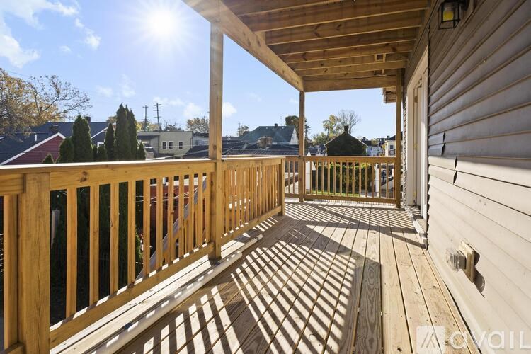 A wooden deck with a sunny sky in the background.