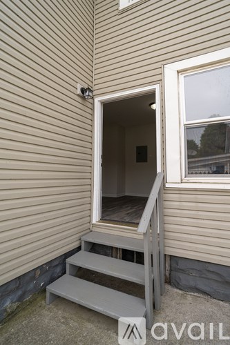 A small doorway with a step leading up to it.