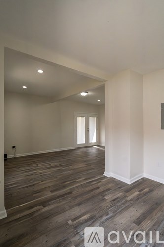 A room with wooden floors and white walls.