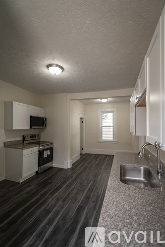A kitchen with a sink and a microwave.