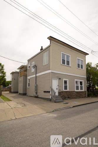 A two-story house with a garage on the side.