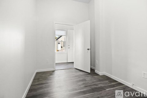 A long pipe runs along the ceiling of a room.