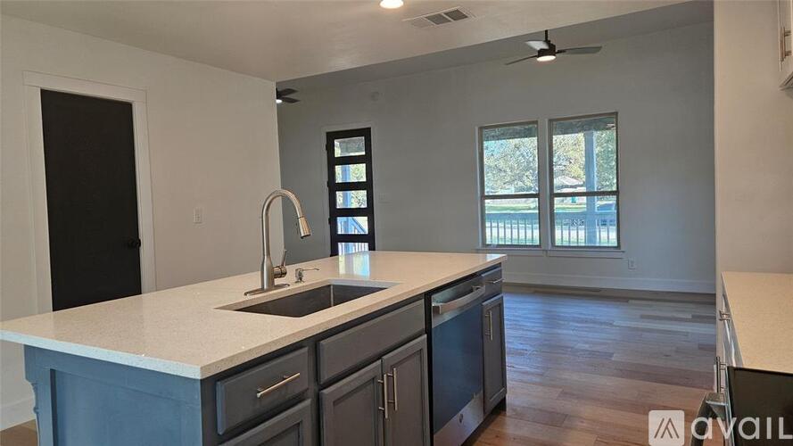 A kitchen with a sink and a window.