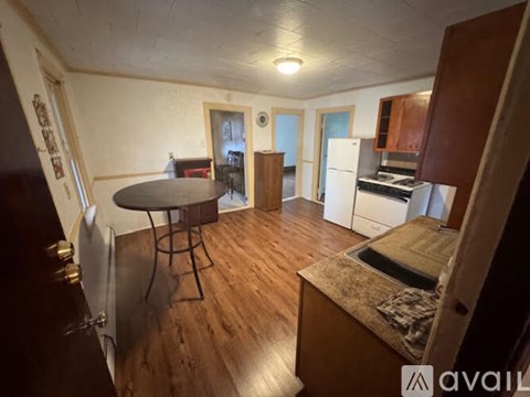 A kitchen with a table and chairs in the middle of the room.