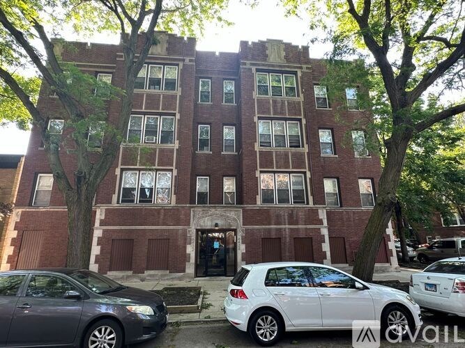A brick building with a tree in front of it.
