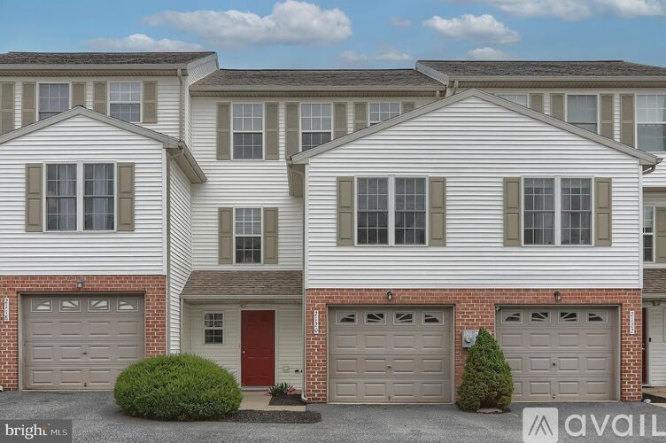 A row of houses with garages and driveways.