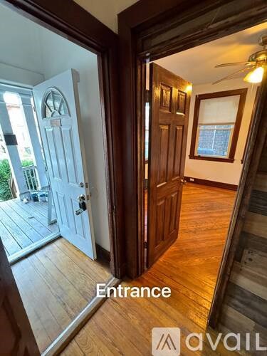 A wooden entrance with a door and a window.