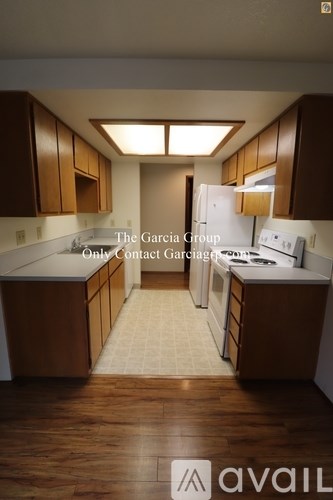 A kitchen with wooden cabinets and a tiled floor.