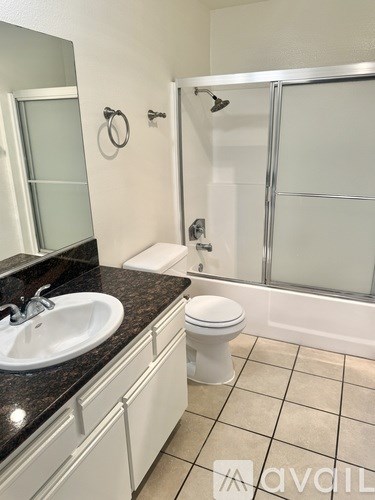 A bathroom with a sink, toilet and shower.