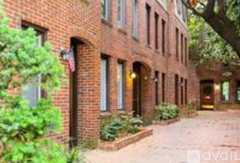 A brick building with a tree in front of it.