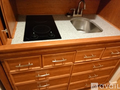 A kitchen with a sink and a stove top.