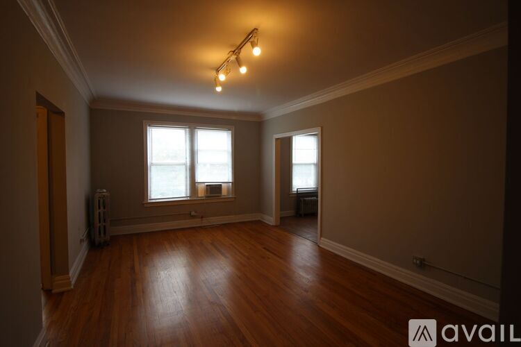 A room with wooden floors and a window.