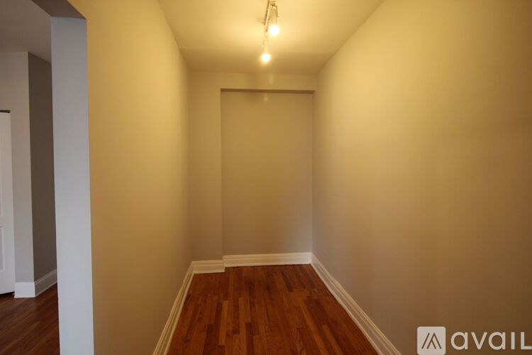 A room with wooden floors and a light on the ceiling.