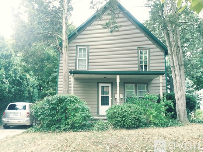 A house with a car parked in front.