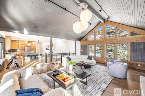 A living room with a white couch and a coffee table with a book on it.