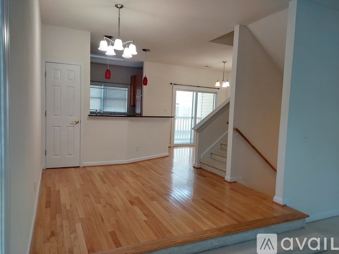 A room with wooden floors and a staircase.