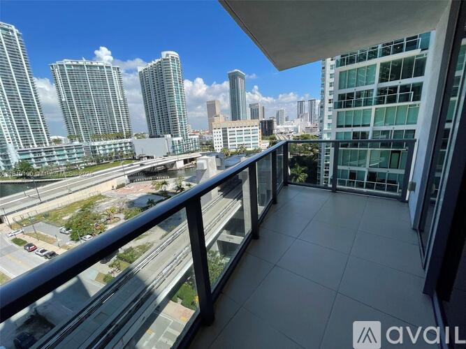 A balcony overlooks a cityscape with tall buildings and a highway.