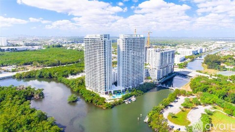 A large building is situated on the edge of a body of water.