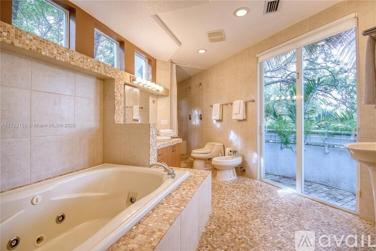 A bathroom with a tub, toilet, and sink.