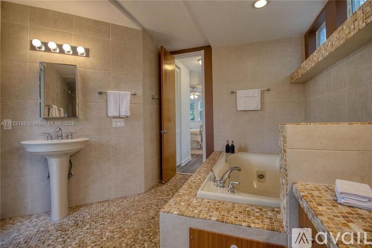 A bathroom with a sink and mirror.