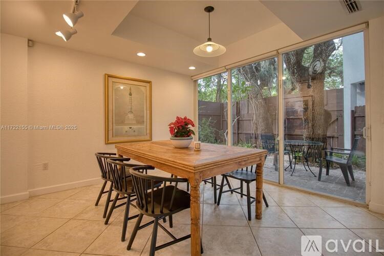 A dining room with a wooden table and chairs.