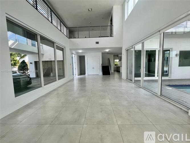 A spacious interior with large glass doors and a tiled floor.