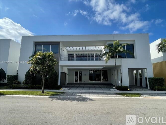 A modern white house with a glass door and windows.
