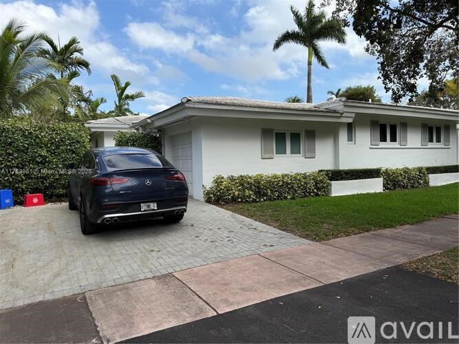 A house with a car parked in front of it.