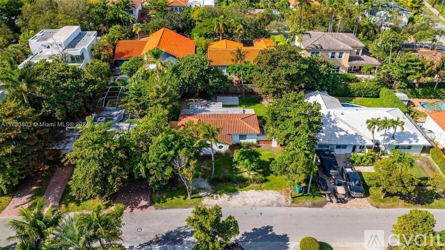A bird's eye view of a residential area with houses and trees.