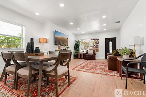 A dining room with a wooden table and chairs.