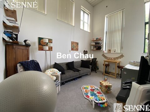 A living room with a grey sofa and a television.