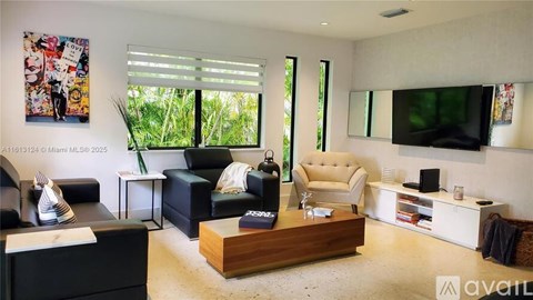 A living room with a black couch, a white couch, and a wooden coffee table.