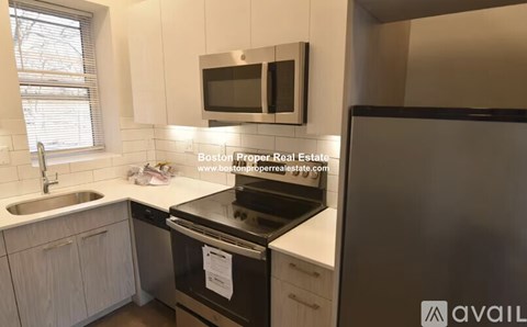 A kitchen with a stove top oven and a microwave above it.