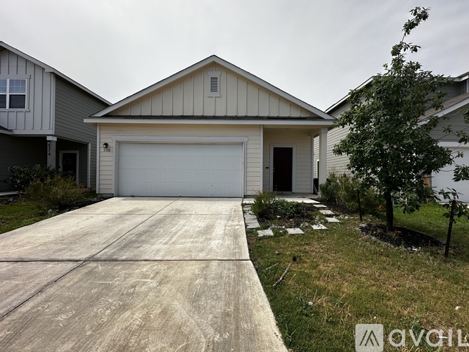 A house with a garage and a driveway.