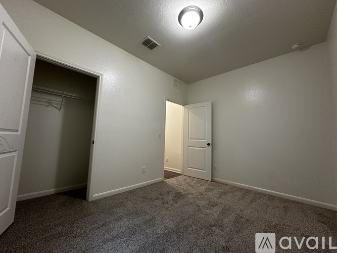 A room with a carpeted floor and a ceiling light.