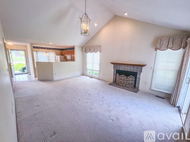 A living room with a fireplace and a carpeted floor.