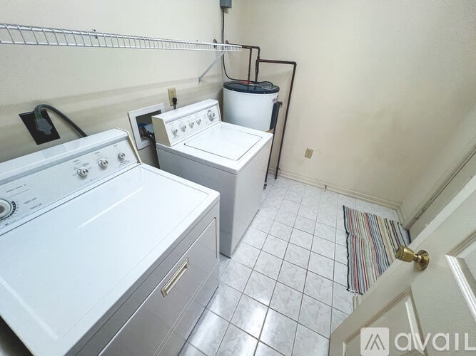 A small laundry room with a washer and dryer.